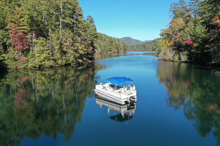 A pontoon boat on calm water. 