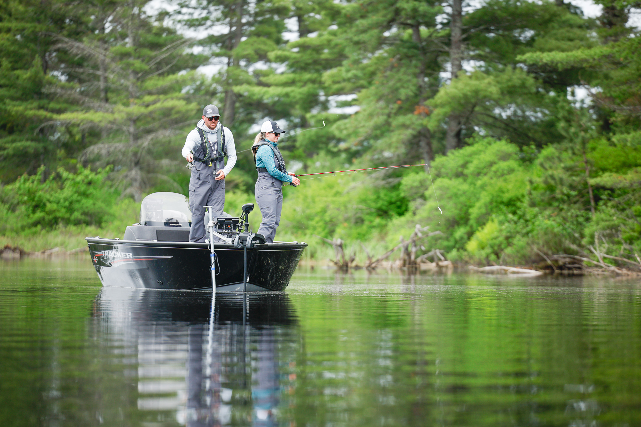 A man and woman fishing from a boat, boat rental MO concept. 