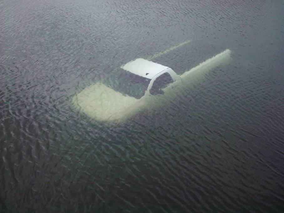 A truck submerged underwater, boat launch failure concept. 